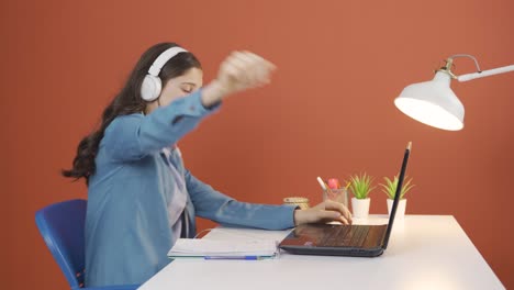 Young-woman-looking-at-laptop-is-happy-and-dancing.